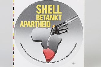 Ausstellungsobjekt: Sticker “Shell betankt Apartheid”, Sticker des Bund der Deutschen Katholischen Jugend (BDKJ), Arbeitsgemeinschaft der Evangelischen Jugend Deutschland und Berlin West (aej), 1988.